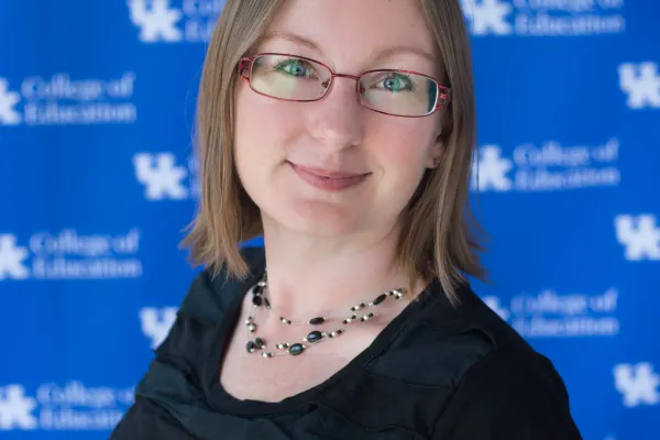 Headshot of Kathleen Aspiranti against blue UK College of Education backdrop