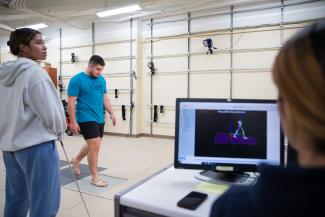 Students performing analysis in the biomechanics lab in the Department of Kinesiology and Health Promotion