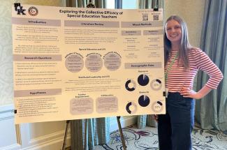 Jones standing by a research poster