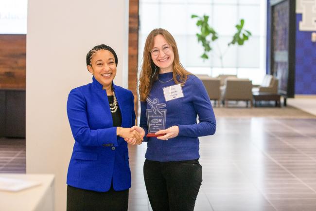 UK College of Education Acting Dean Danelle Stevens-Watkins presents a Teachers Who Made a Difference award to an educator.