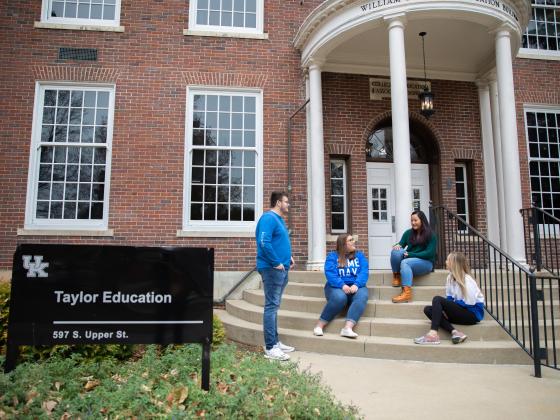 Students sitting on the steps of Taylor Education Building