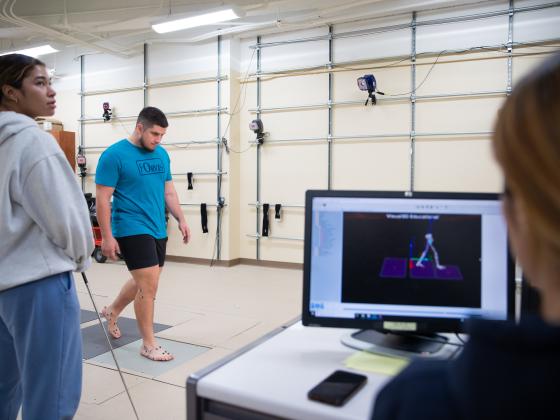 Students in kinesiology lab studying the motion of a person walking